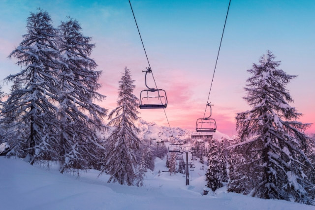 Ski lifts in front of the sunset