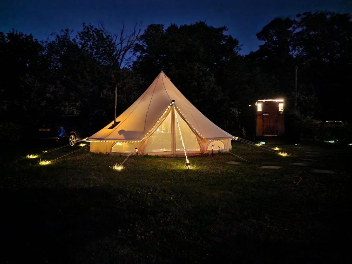 A bell tent at Quex Livery Glamping near London at dusk